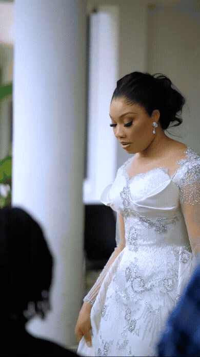 First Lady of Imo State, Chioma Uzodimma, wears a custom ecru TUBỌ bridal gown with beaded Chantilly lace and detachable cape for her 10th wedding anniversary vow renewal.