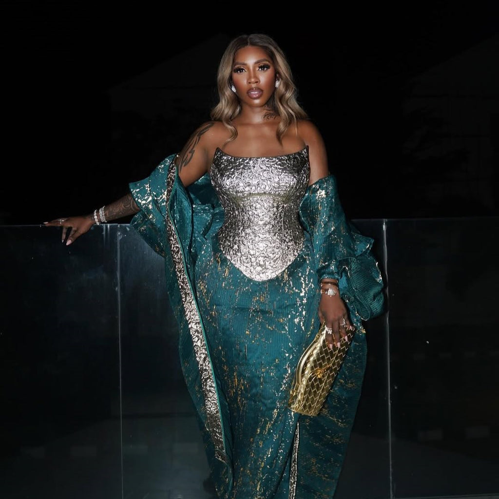 Tiwa Savage in Emerald Ivy Look, Gold Damask Corset Highlight: Tiwa Savage poses gracefully in the Emerald Ivy Agbada and Midi Skirt with the shimmering Gold Petal Corset, in tubowoman.