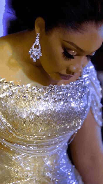First Lady of Imo State, Chioma Uzodimma, wearing a custom cream TUBỌ gown with rose-beaded details and shimmering embellishments for her 10th wedding anniversary celebration.