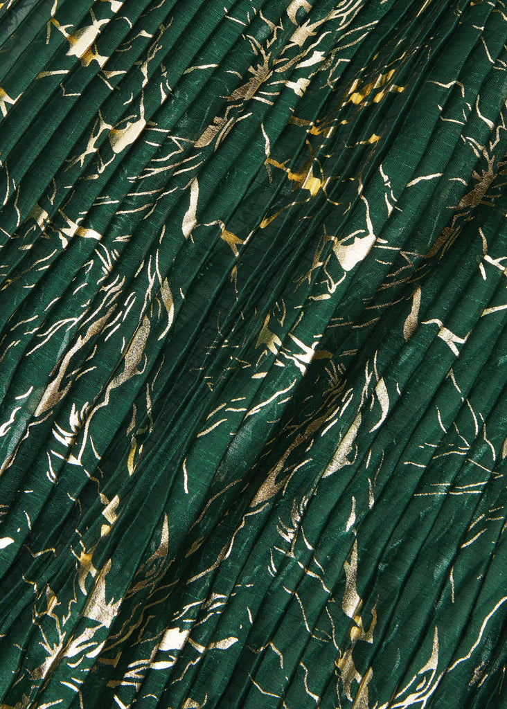 Close up rich green and gold organza damask. Organza damask is lightweight yet structured, making it the perfect partner for a piece that’s bold, playful, and utterly sophisticated.